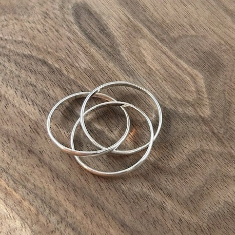 Three intertwined sterling silver rings, symbolizing the unbreakable bond between family members. Handcrafted on an 18” silver chain.