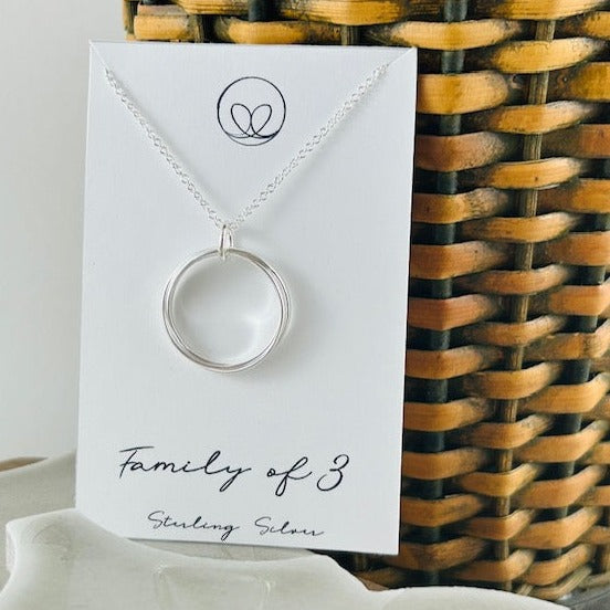Family of 3 sterling silver necklace with five intertwined rings, symbolizing the unbreakable bond between family members. Handcrafted on an 18” silver chain