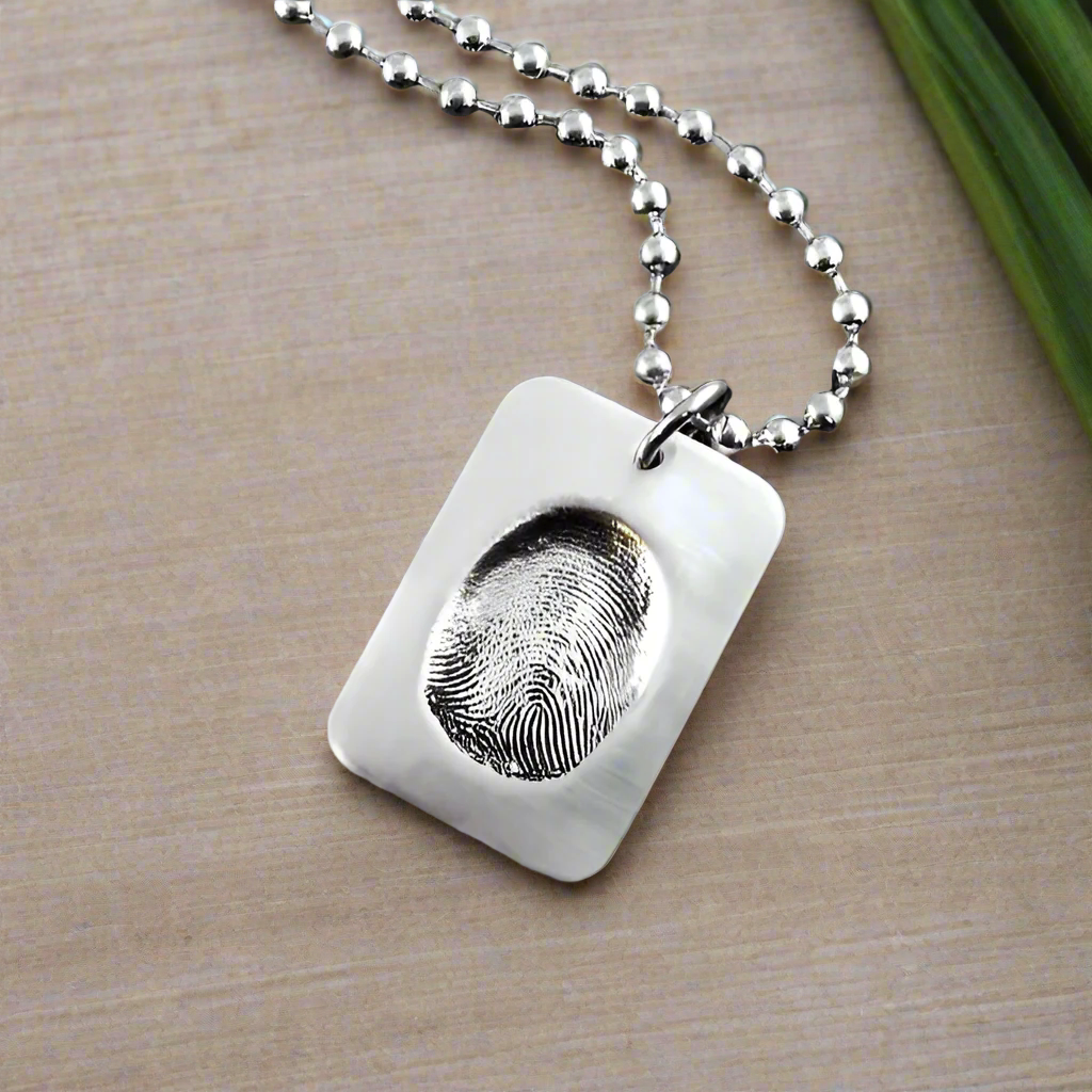 Dog Tag shape fine silver fingerprint pendant showcasing the exact indentation of a loved one's finger, crafted from a putty print for a unique and sentimental keepsake.