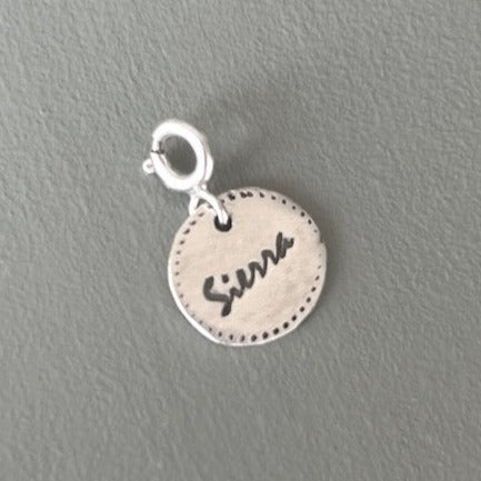 Handmade fine silver round name charm in 99.9% pure silver with a clasp for easy attachment to the 'Always Necklace' or any necklace or bracelet.