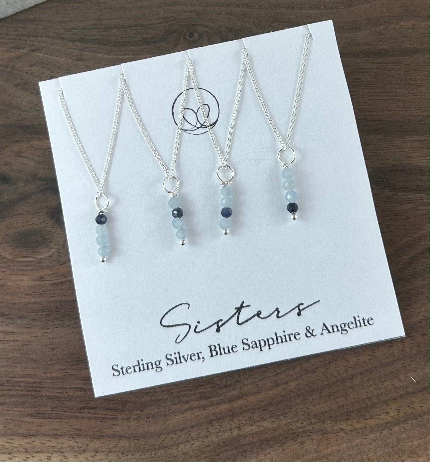 Sister necklace set featuring Iolite stones, subtly symbolizing the bond between siblings. The darker stone placement represents the older or younger sister.  This set includes 4 separate necklaces.