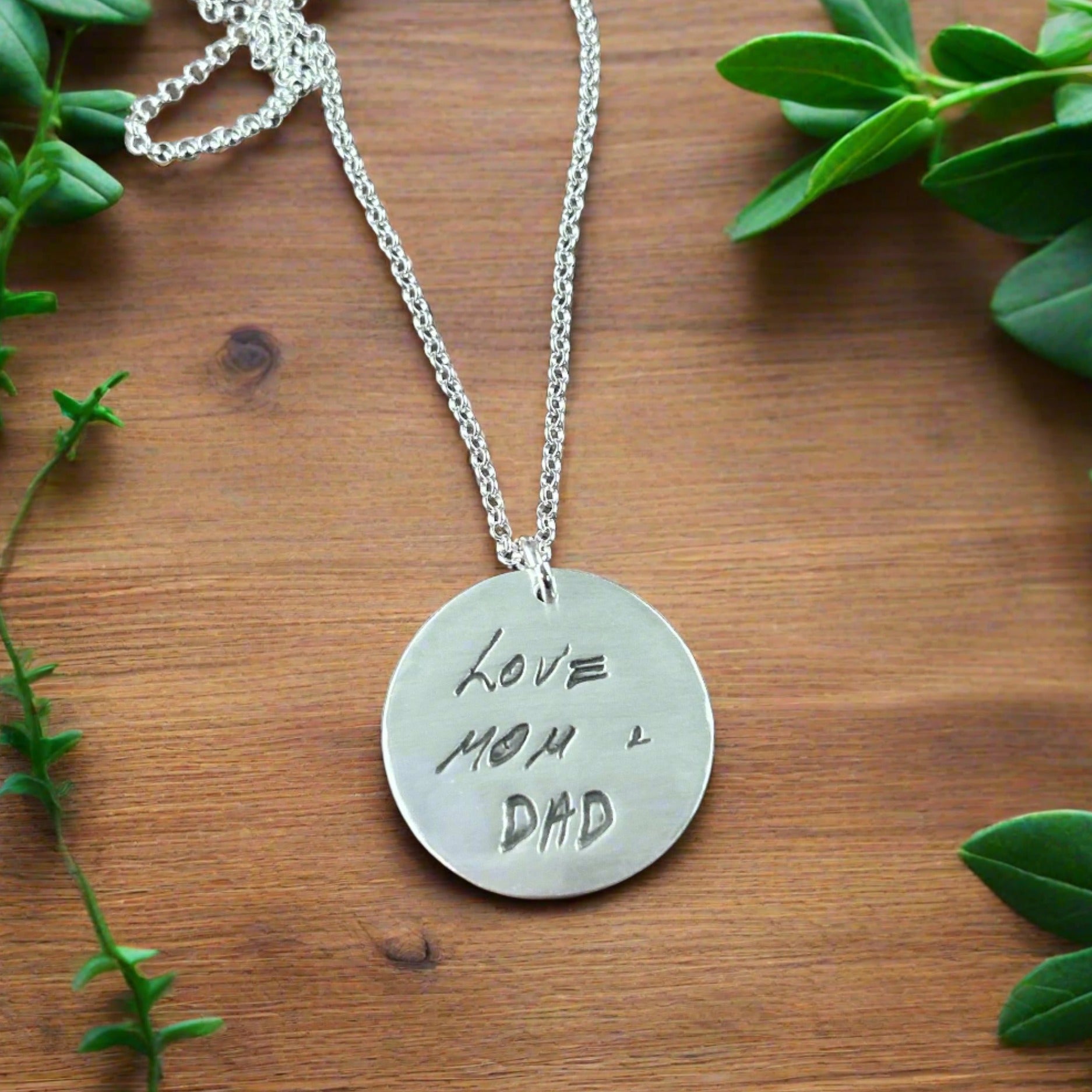 Fine silver large circle pendant showcasing a handwritten message from a loved one. Customize with personal writing or text from a cherished letter or card.