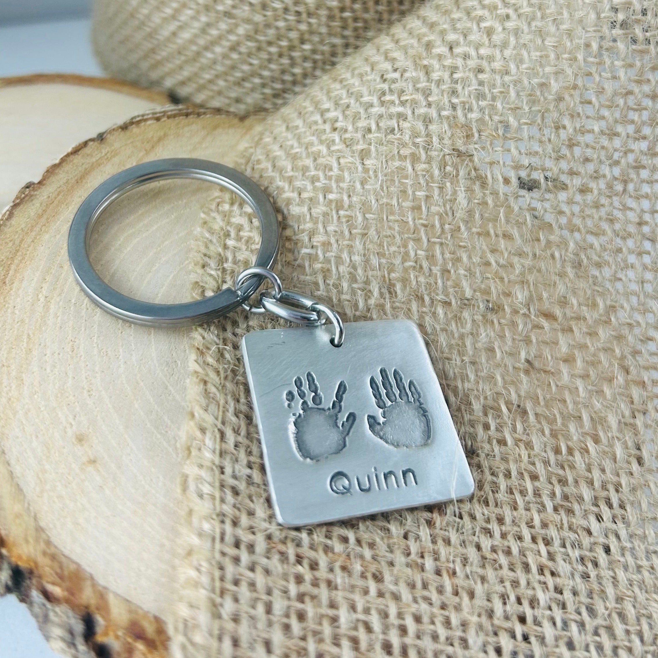 Fine silver square pendant showcasing actual hand and/or footprints. A meaningful keepsake, customizable with an optional chain or keyring.