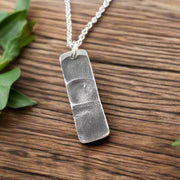 Handmade rectangle shape pendant with 3 family members fingerprints.
