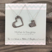 Handcrafted 99.9% fine silver mother-daughter necklace set with a necklace for each of you.  One necklace with a larger heart, the other necklace has a smaller heart.