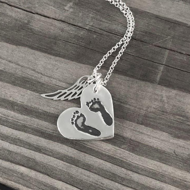 Fine silver pendant showcasing actual hand and/or footprints. Personalize with one or two prints and complete with an optional chain or embellishment.