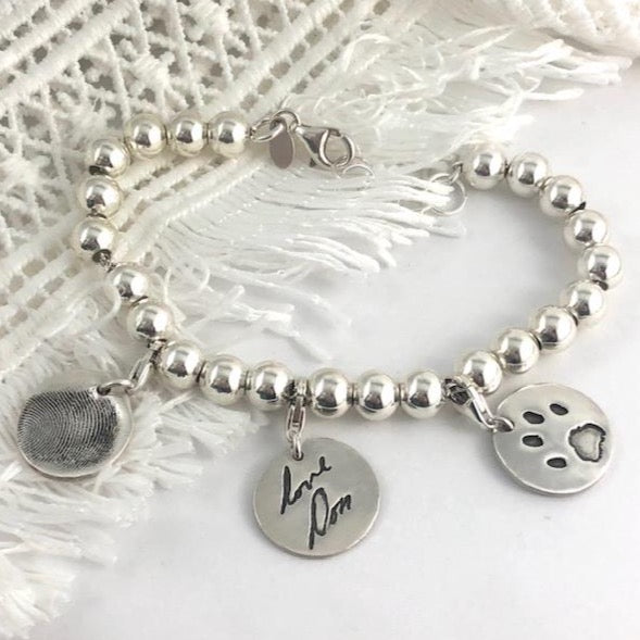 Sterling silver charm bracelet, a meaningful alternative to a family ring. Add charms for each loved one, easily rearrangeable with sterling lobster clasps.