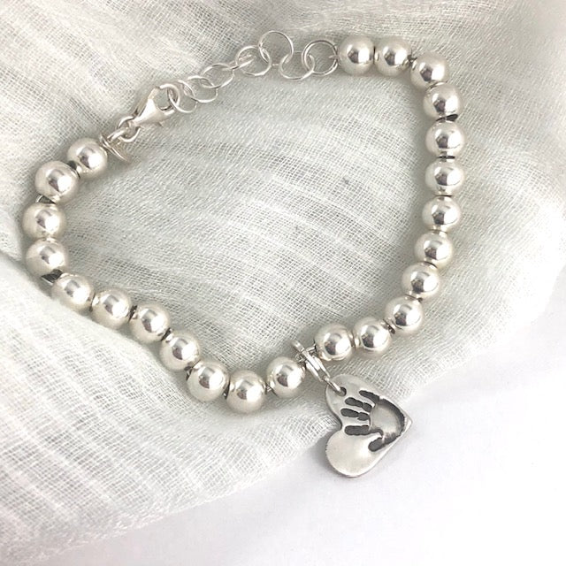 Sterling silver charm bracelet, a meaningful alternative to a family ring. Add charms for each loved one, easily rearrangeable with sterling lobster clasps.
