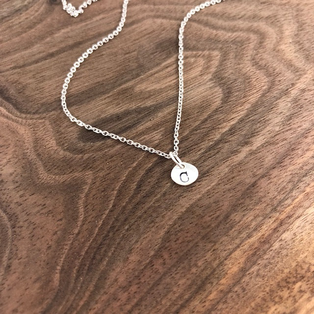 Tiny sterling silver initial necklace with hand-stamped 6x7mm charms. Simple and elegant, available with a 16" or 18" chain and optional extra charms.