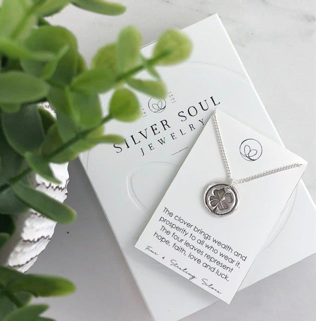 Fine silver four-leaf clover necklace, handcrafted from 99.9% pure silver, symbolizing luck, love, and prosperity for the wearer.