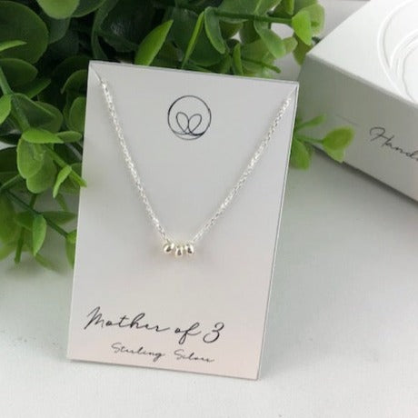 Sterling silver mother necklace with three beads, symbolizing love and connection. Handmade with care for a meaningful and sentimental keepsake.