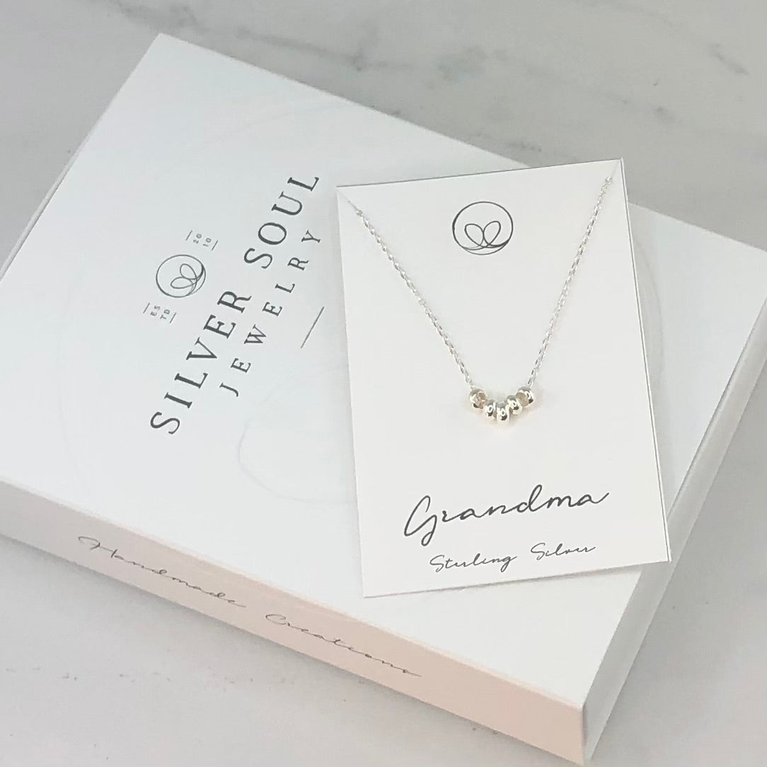 Sterling silver necklace for a grandmother, featuring delicate beads representing each grandchild—a meaningful and sentimental family keepsake.