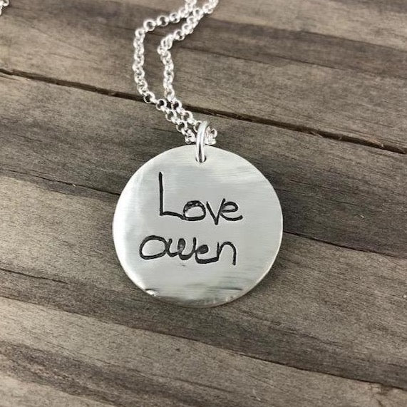 Fine silver large circle pendant showcasing a handwritten message from a loved one. Customize with personal writing or text from a cherished letter or card.