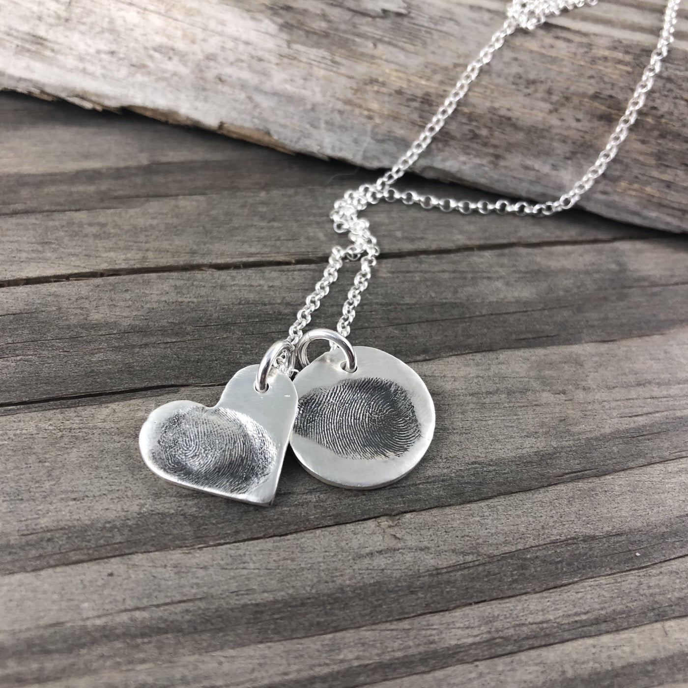 Small circle fine silver fingerprint pendant, handcrafted to preserve the exact shape and indentation of a loved one’s finger for a unique and sentimental keepsake.