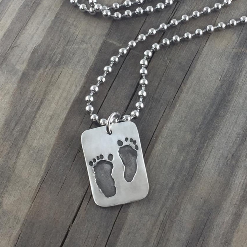 Fine silver dog tag pendant for men, personalized with real hand and/or footprints. A meaningful keepsake to honor a loved one's unique touch.