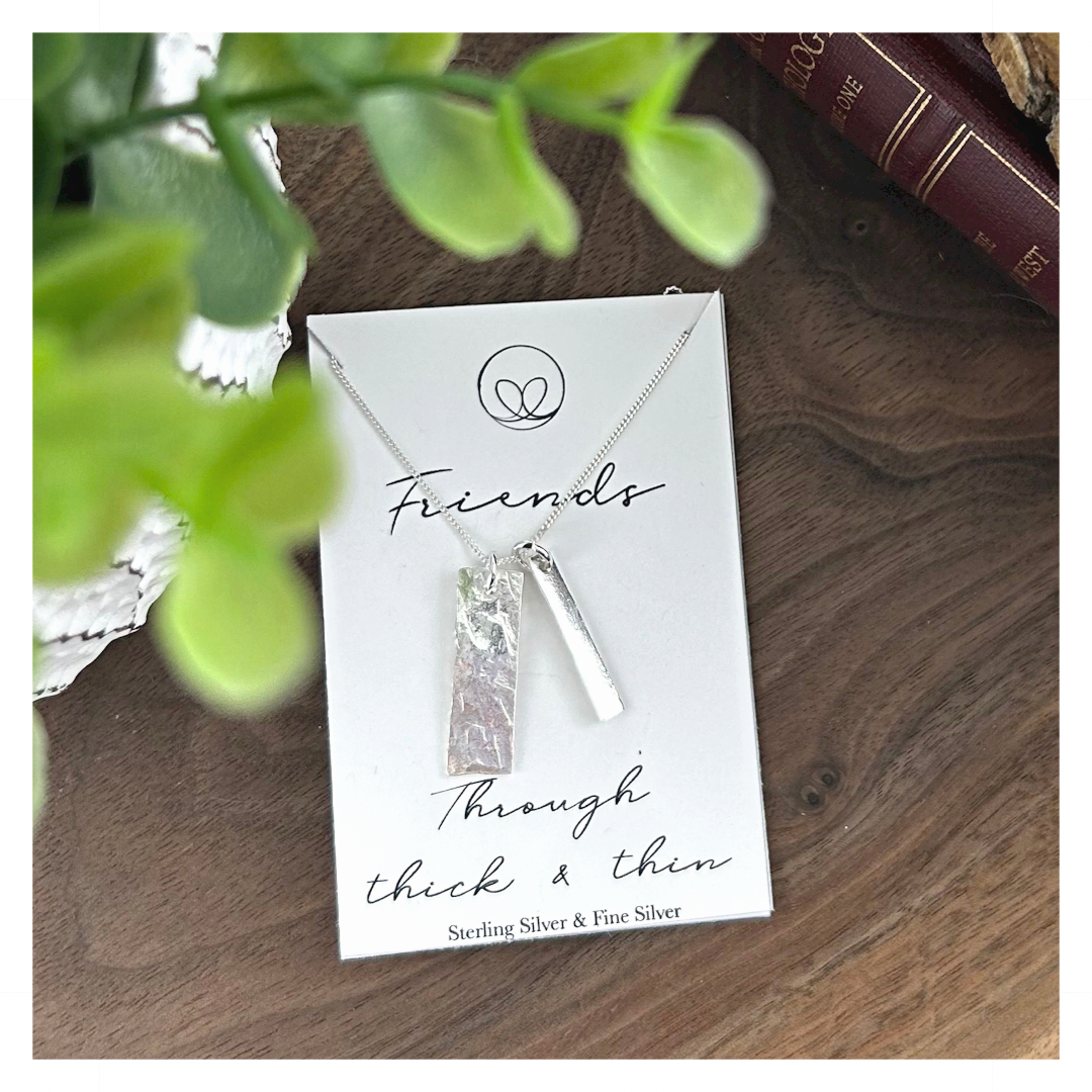 Sterling silver necklace with 2 handmade charms.  One thick and one thin.  Representing friends who have been together through thick and thin.