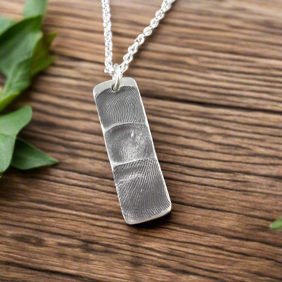 Handmade rectangle shape pendant with 3 family members fingerprints. 