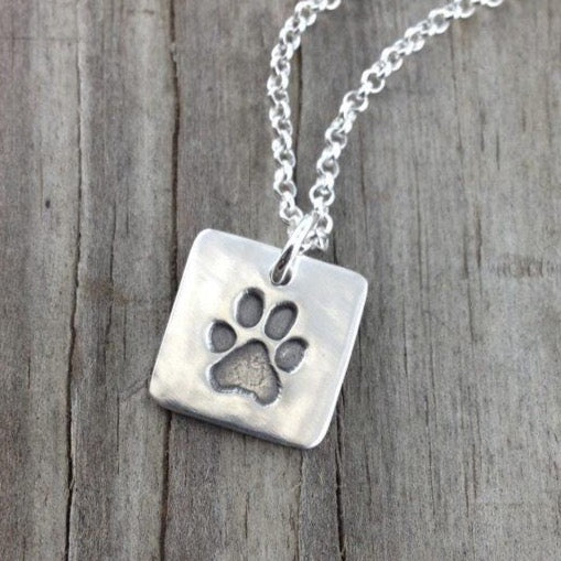 Fine silver square shape paw print pendant, handcrafted to showcase your pet’s actual print. A simple, meaningful keepsake with optional chain or embellishment.