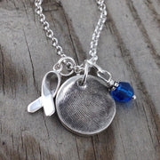 Small circle fine silver fingerprint pendant, handcrafted to preserve the exact shape and indentation of a loved one’s finger for a unique and sentimental keepsake.