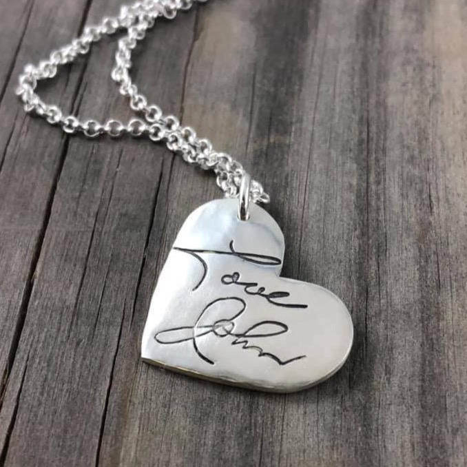 Fine silver heart pendant showcasing a handwritten message. Personalize with up to 10 letters from a letter, card, or your own writing. Optional chain available.