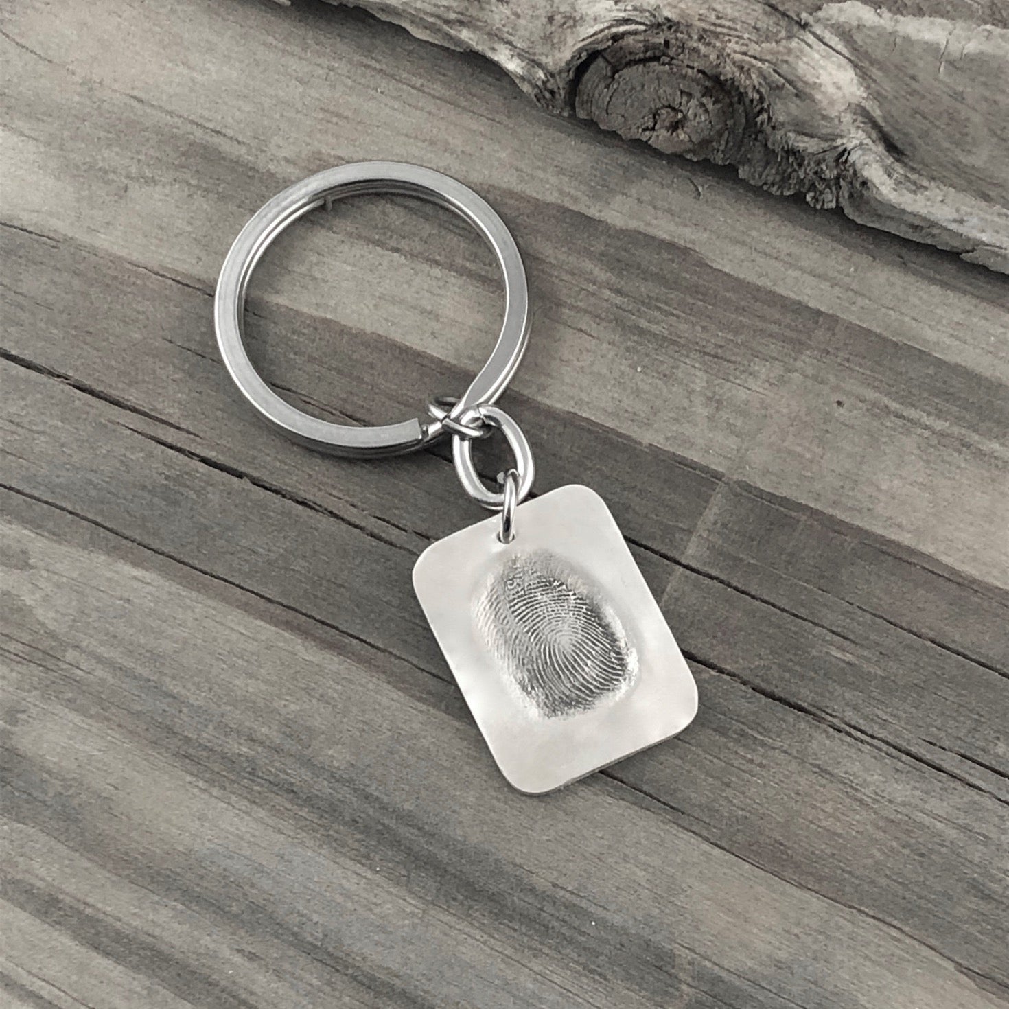 Dog Tag shape fine silver fingerprint pendant showcasing the exact indentation of a loved one's finger, crafted from a putty print for a unique and sentimental keepsake.
