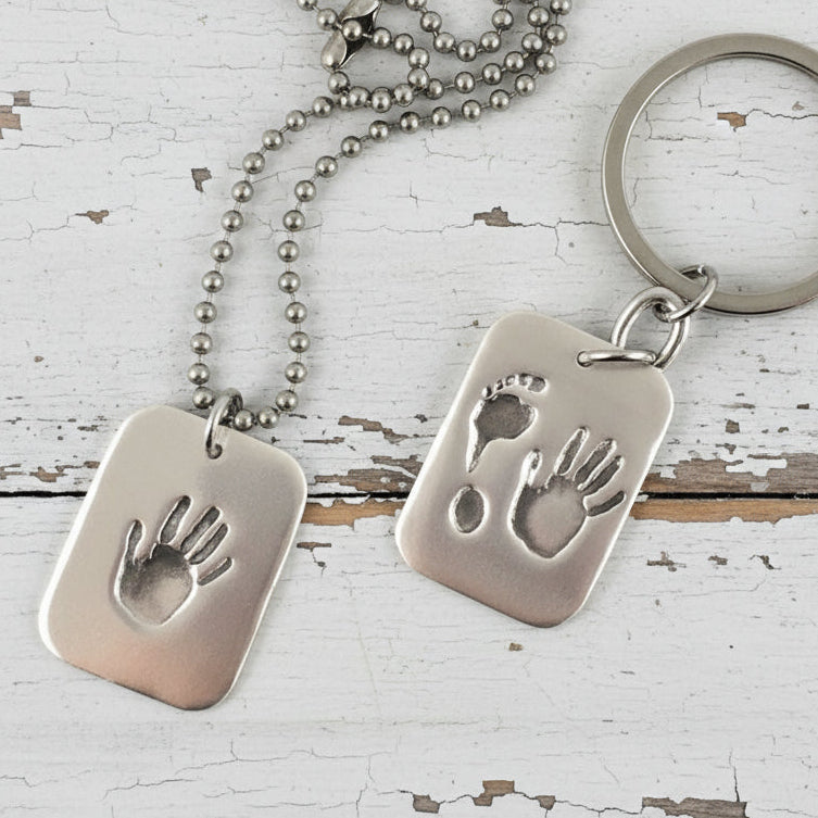 Fine silver dog tag pendant for men, personalized with real hand and/or footprints. A meaningful keepsake to honor a loved one's unique touch.