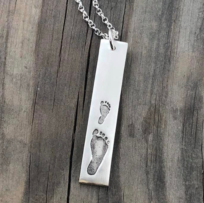Handmade fine silver rectangle shaped pendant featuring up to 3 actual hand and/or footprints of a loved one. Customize with an optional chain or embellishment for a special touch.