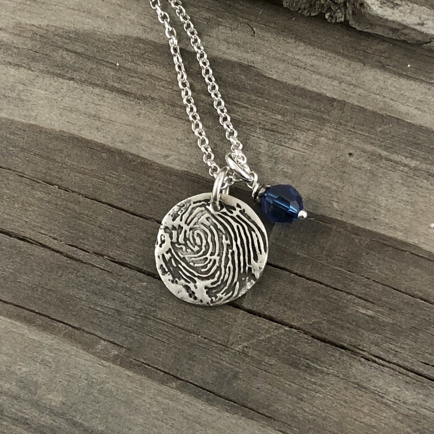 Fine silver circle fingerprint pendant, handcrafted from paper prints with enhanced detail. A meaningful keepsake with an optional chain or embellishment.
