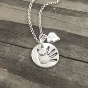 Small handcrafted fine silver circle pendant your child's actual  hand or footprint.