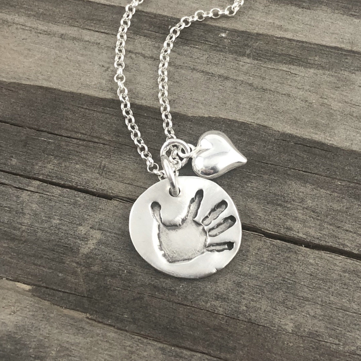 Small handcrafted fine silver circle pendant your child's actual  hand or footprint.