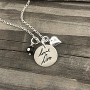 Small handcrafted fine silver circle pendant featuring a replica of a loved one's handwriting, creating a meaningful and personalized keepsake.