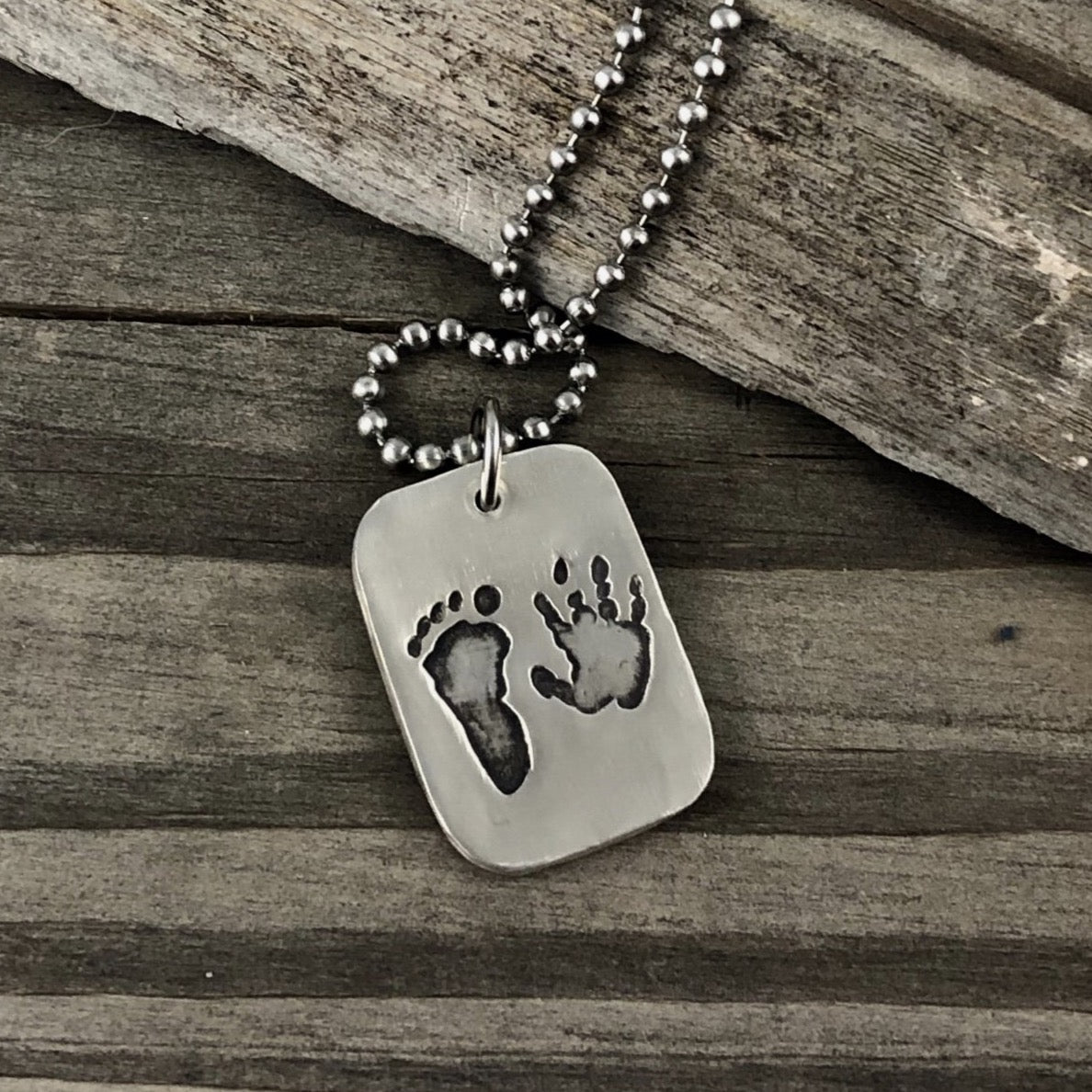 Fine silver dog tag pendant for men, personalized with real hand and/or footprints. A meaningful keepsake to honor a loved one's unique touch.