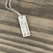 Graduation necklace featuring custom coordinates, symbolizing home or a first school. A meaningful keepsake for students starting a new journey.