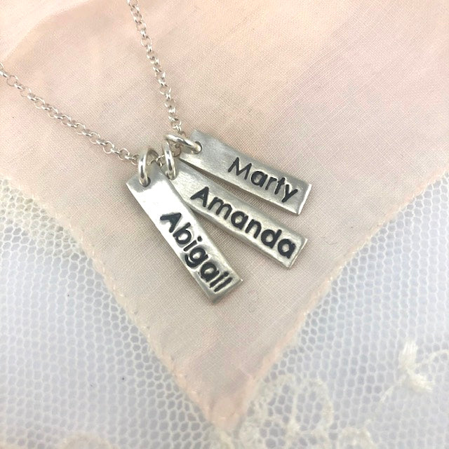 Personalized fine silver name tag necklace with up to 3 custom tags. Comes with an 18” rolo chain, with the option to upgrade for a longer length.