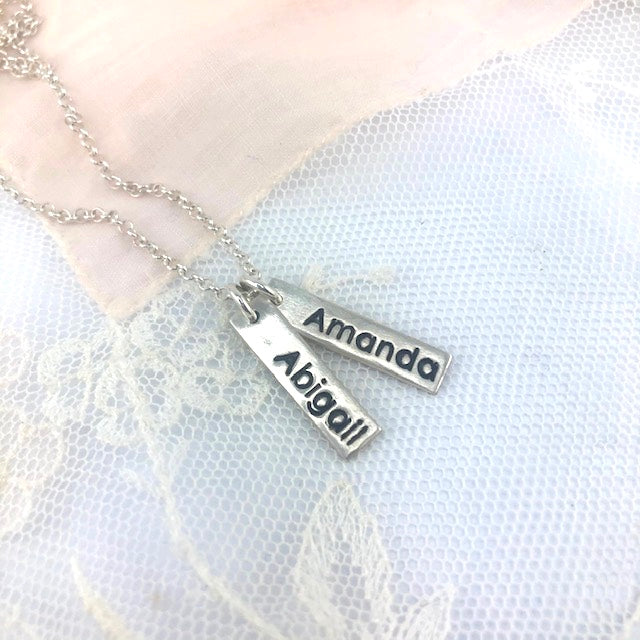 Personalized fine silver name tag necklace with up to 3 custom tags. Comes with an 18” rolo chain, with the option to upgrade for a longer length.